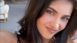 Kylie Jenner nearly spills out of white bikini top before posing with all four of her sisters in rare snap