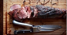 This smoky, fire-kissed beef tenderloin with herb butter ...