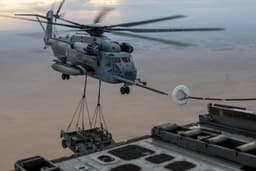 U.S. Marines Conduct CH-53E Helicopter Refueling While Lifting 2 Vehicles in Combat Test
