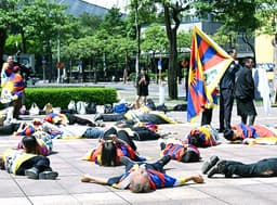 Tibetan activists protest China ethnic unity law at bank