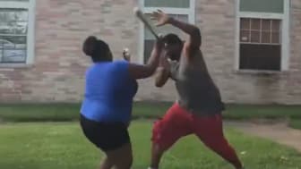 Fight breaking out at a Houston apartment complex when a woman, swinging a baseball bat, starts hitting a man