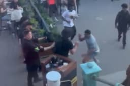 Moment yobs brawl on packed beach as security guard films chaos erupting on hottest day of the year