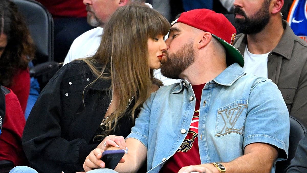 Taylor Swift & Travis Kelce’s 10 Best Moments at Cavs Game: Courtside Kiss, Chugging Beer, Switching Shirts, & More!